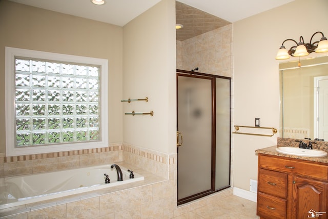 bathroom featuring a stall shower, vanity, a garden tub, and tile patterned floors