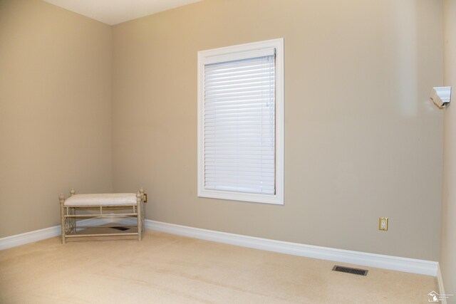empty room featuring carpet flooring and baseboards