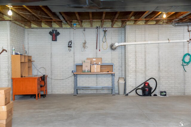 unfinished below grade area featuring brick wall
