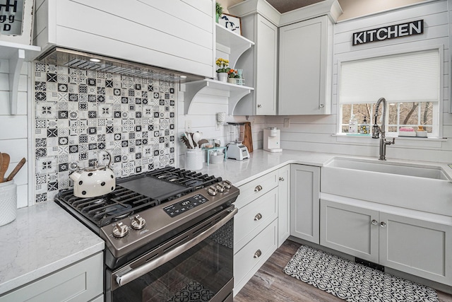 7379 Wimpole Dr NE, Belding, MI 48809 - kitchen with stainless steel gas range oven, open shelves, a sink, and decorative backsplash