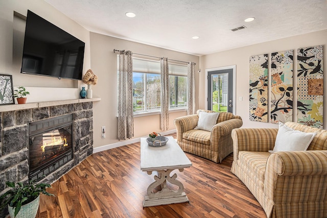 7379 Wimpole Dr NE, Belding, MI 48809 - living area featuring wood finished floors, recessed lighting, a stone fireplace, and baseboards