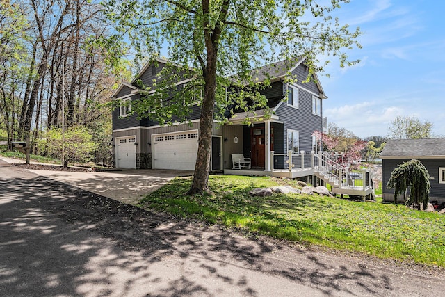 7379 Wimpole Dr NE, Belding, MI 48809 - view of front of property with an attached garage, concrete driveway, and a front lawn