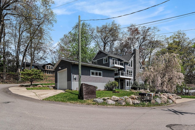 7379 Wimpole Dr NE, Belding, MI 48809 - view of side of home with a chimney and concrete driveway