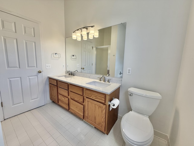 bathroom featuring toilet, a shower stall, tile patterned flooring, and double vanity