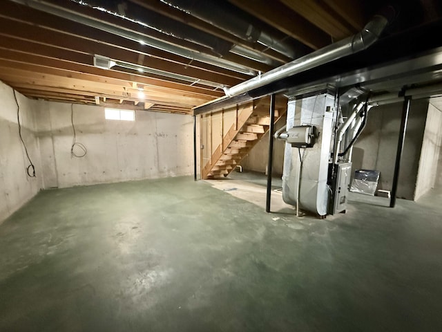 below grade area with stairway and heating unit