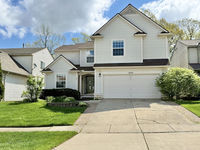 traditional-style home featuring driveway, an attached garage, a front yard, and a shingled roof