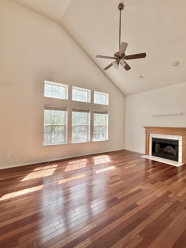 unfurnished living room with high vaulted ceiling, a fireplace, wood-type flooring, a ceiling fan, and recessed lighting