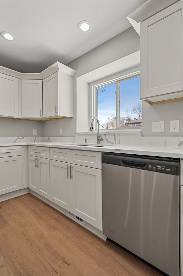 53302 Zachary Dr, Chesterfield, MI 48047 - kitchen with stainless steel dishwasher, a sink, light wood-style floors, white cabinets, and recessed lighting
