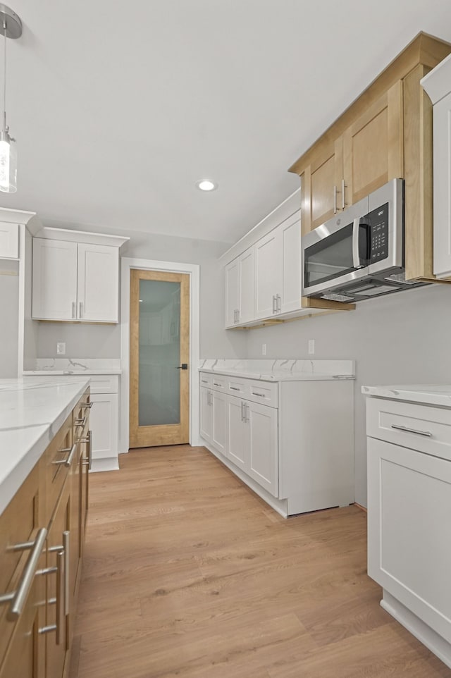53302 Zachary Dr, Chesterfield, MI 48047 - kitchen featuring stainless steel microwave, recessed lighting, light wood finished floors, and white cabinets