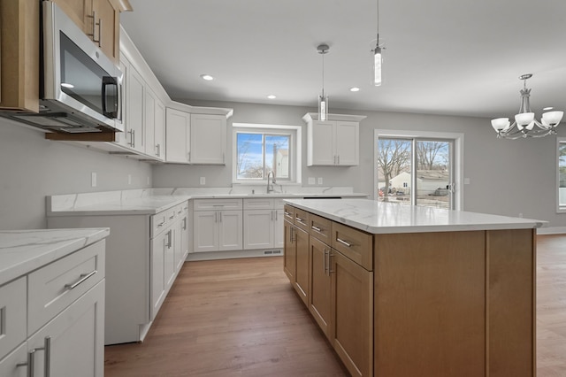 53302 Zachary Dr, Chesterfield, MI 48047 - kitchen featuring stainless steel microwave, plenty of natural light, light wood finished floors, and recessed lighting