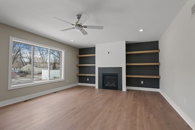 53302 Zachary Dr, Chesterfield, MI 48047 - unfurnished living room with wood finished floors, a ceiling fan, baseboards, a large fireplace, and recessed lighting