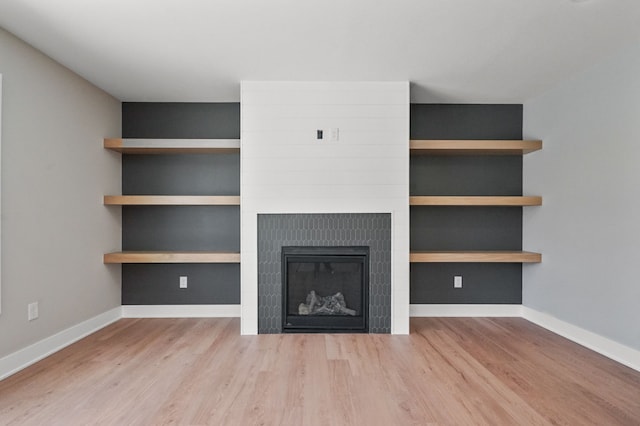 53302 Zachary Dr, Chesterfield, MI 48047 - unfurnished living room featuring wood finished floors, baseboards, and a glass covered fireplace