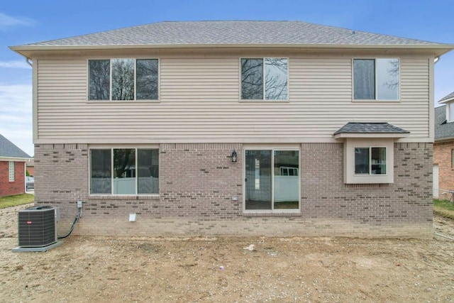53302 Zachary Dr, Chesterfield, MI 48047 - back of house featuring central AC, brick siding, and roof with shingles