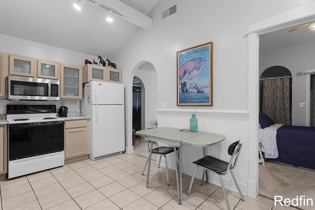 16153 Krob Rd, Union Pier, MI 49129 - kitchen featuring electric stove, freestanding refrigerator, stainless steel microwave, track lighting, and arched walkways