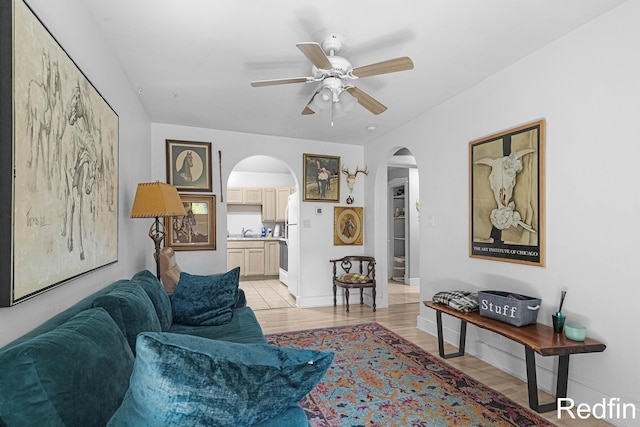 16153 Krob Rd, Union Pier, MI 49129 - living area featuring arched walkways, ceiling fan, light wood-style flooring, and baseboards