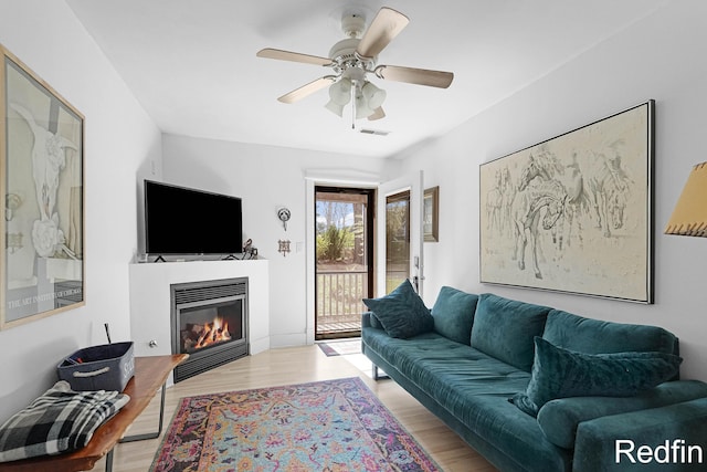 16153 Krob Rd, Union Pier, MI 49129 - living room with a glass covered fireplace, wood finished floors, and ceiling fan