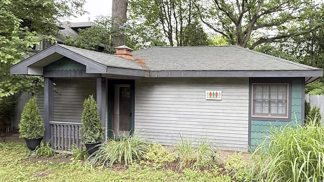 16153 Krob Rd, Union Pier, MI 49129 - view of property exterior with a shingled roof and a chimney