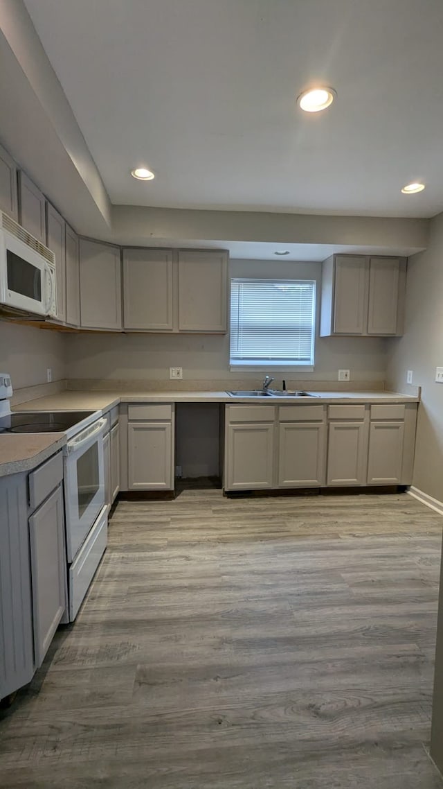 19205 Stanley St, Melvindale, MI 48122 - kitchen with white appliances, a sink, light wood finished floors, gray cabinetry, and recessed lighting