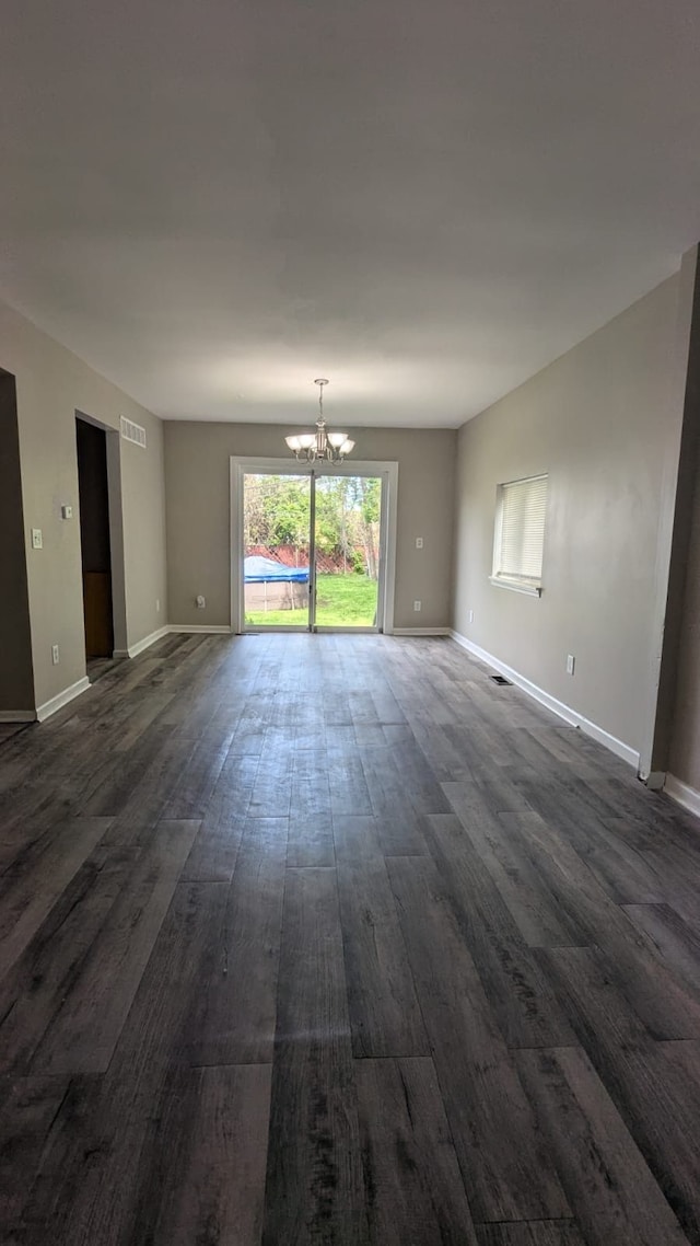 19205 Stanley St, Melvindale, MI 48122 - spare room with dark wood finished floors, a chandelier, and baseboards