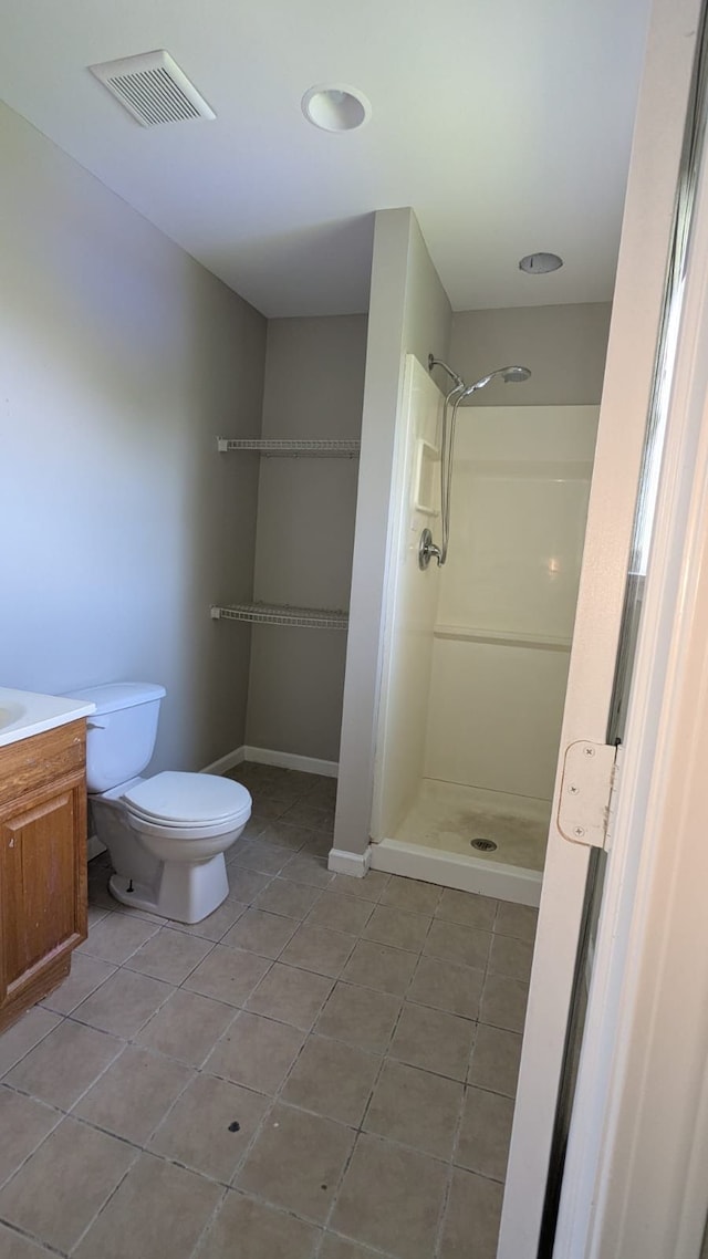19205 Stanley St, Melvindale, MI 48122 - bathroom with tile patterned flooring, a walk in shower, toilet, and vanity