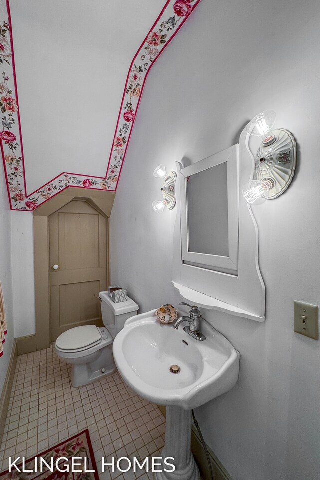 223 E Savidge St, Spring Lake, MI 49456 - half bathroom with toilet, a sink, and tile patterned floors
