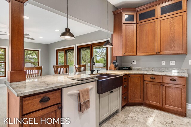 223 E Savidge St, Spring Lake, MI 49456 - kitchen with white dishwasher, a peninsula, brown cabinetry, recessed lighting, and decorative light fixtures