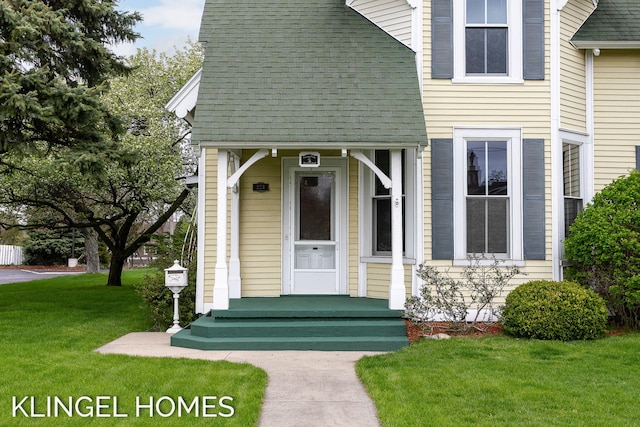 223 E Savidge St, Spring Lake, MI 49456 - view of front of property featuring a shingled roof and a front yard