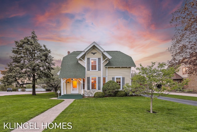 223 E Savidge St, Spring Lake, MI 49456 - view of front of house with a lawn, a chimney, and a shingled roof