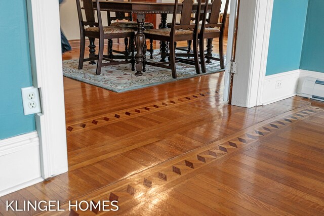 223 E Savidge St, Spring Lake, MI 49456 - detailed view of wainscoting, a baseboard radiator, and wood finished floors
