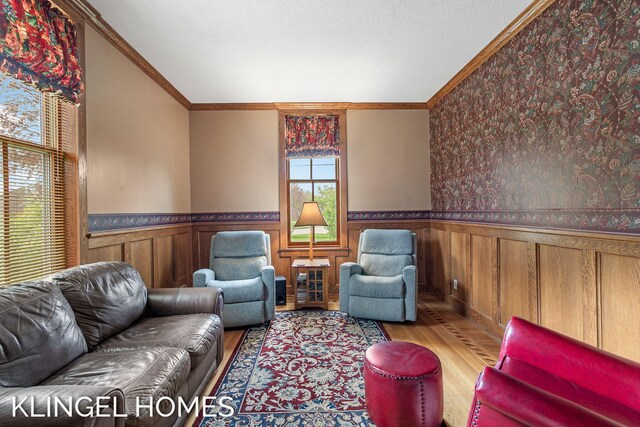 223 E Savidge St, Spring Lake, MI 49456 - living room with a wainscoted wall, wood finished floors, and ornamental molding