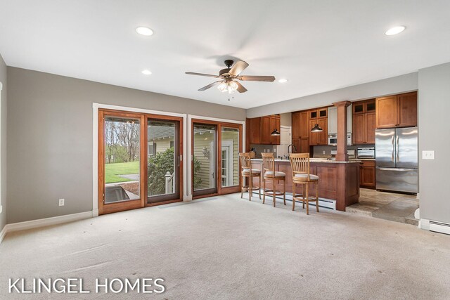 223 E Savidge St, Spring Lake, MI 49456 - kitchen featuring stainless steel fridge, brown cabinetry, light carpet, baseboards, and recessed lighting