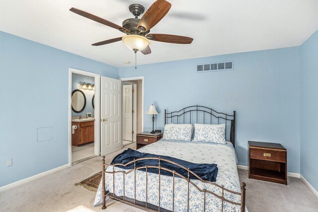 bedroom with carpet, baseboards, ensuite bath, and ceiling fan