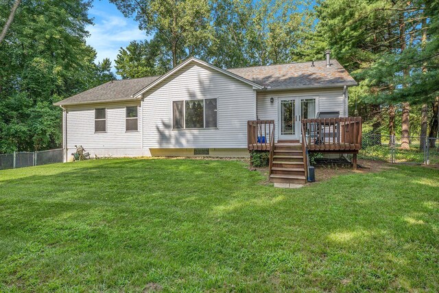 rear view of house featuring a wooden deck and roof with shingles