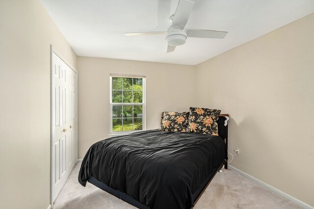 bedroom with light carpet, baseboards, and ceiling fan