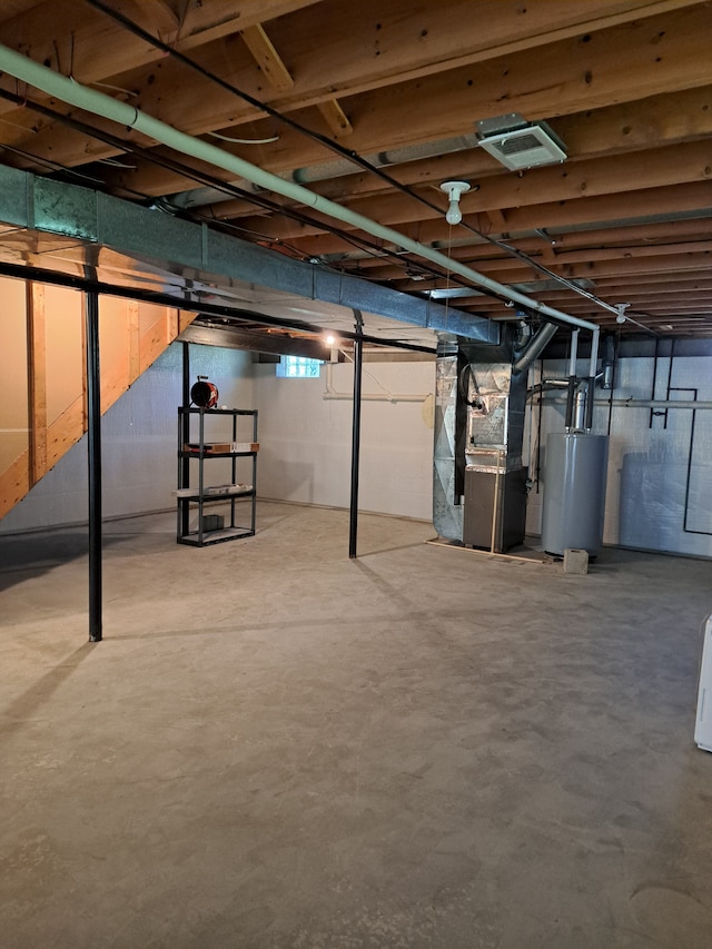 basement featuring water heater and heating unit