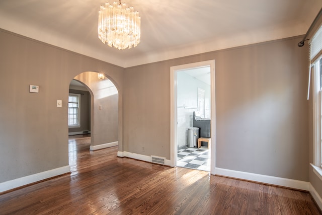 20121 Briarcliff Rd, Detroit, MI 48221 - empty room featuring baseboards, arched walkways, plenty of natural light, and wood finished floors