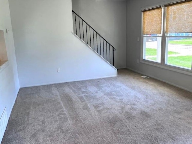 9455 N Parkwood Dr, Davison, MI 48423 - unfurnished living room featuring carpet, stairs, and baseboards