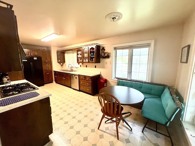 103 Lukesport Dr, Quincy, MI 49082 - kitchen with freestanding refrigerator, dishwasher, a sink, light countertops, and glass insert cabinets