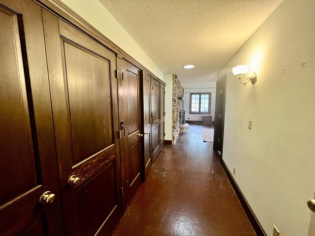 103 Lukesport Dr, Quincy, MI 49082 - hall with baseboards, a textured ceiling, and finished concrete flooring