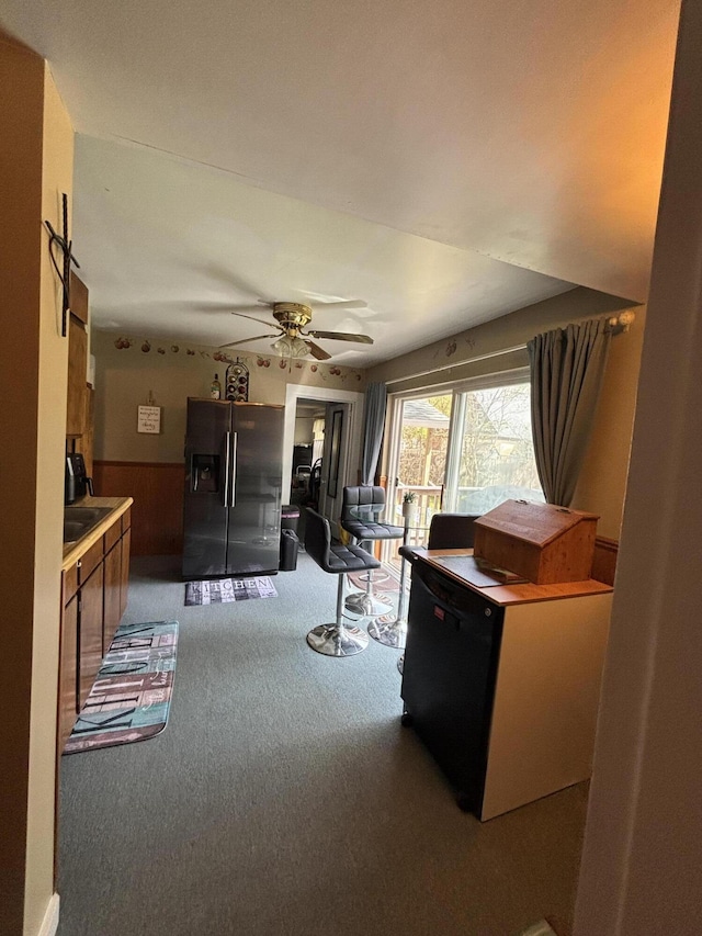 410 S Union St, Hart, MI 49420 - carpeted living room featuring ceiling fan and a wainscoted wall