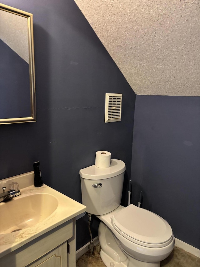 410 S Union St, Hart, MI 49420 - bathroom featuring lofted ceiling, a textured ceiling, toilet, vanity, and baseboards