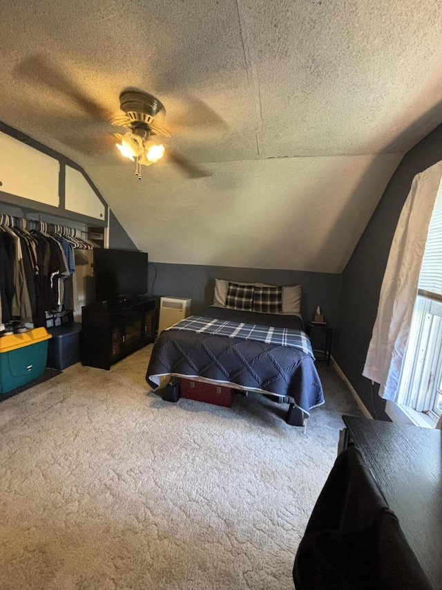 410 S Union St, Hart, MI 49420 - carpeted bedroom featuring a textured ceiling, vaulted ceiling, a ceiling fan, and a closet