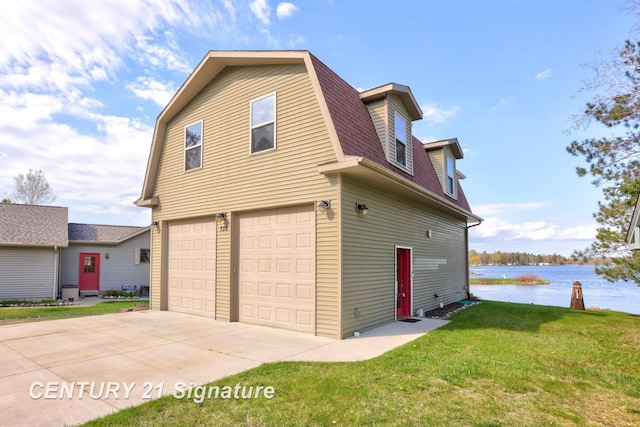 730 S Point Rd, Gladwin, MI 48624 - view of side of home with an attached garage, a gambrel roof, a water view, a lawn, and a shingled roof