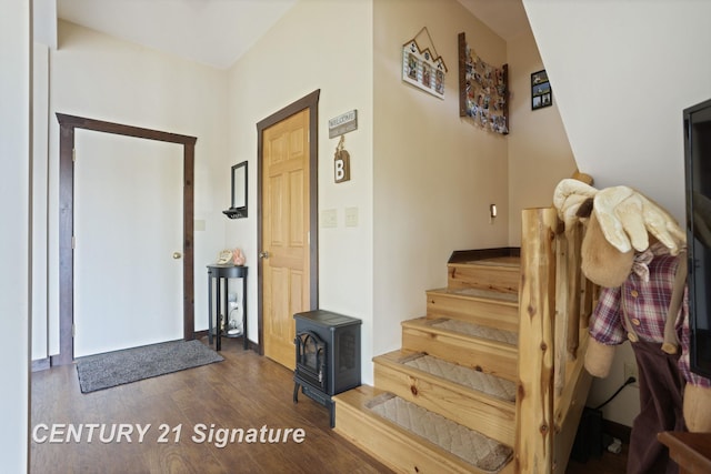 730 S Point Rd, Gladwin, MI 48624 - entrance foyer with wood finished floors, stairway, and a wood stove