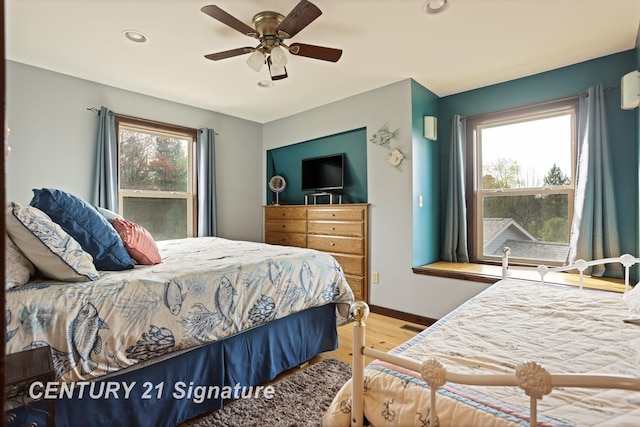 730 S Point Rd, Gladwin, MI 48624 - bedroom with wood finished floors, recessed lighting, baseboards, and ceiling fan