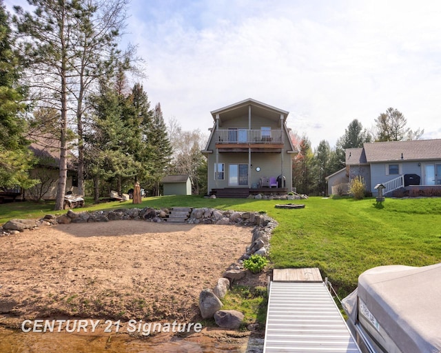 730 S Point Rd, Gladwin, MI 48624 - back of property featuring a balcony and a lawn
