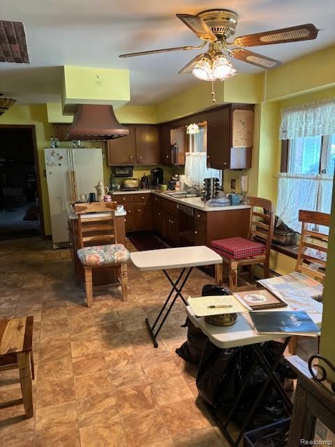 25370 Chapelweigh Dr, Farmington Hills, MI 48336 - kitchen with freestanding refrigerator, a ceiling fan, dark brown cabinetry, island range hood, and light countertops