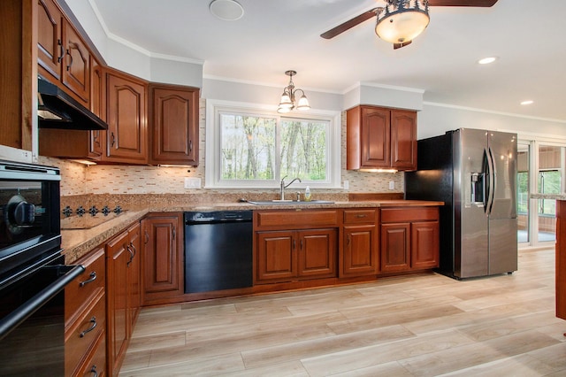 1507 Pinehurst Ln, Niles, MI 49120 - kitchen with black appliances, a sink, under cabinet range hood, brown cabinets, and plenty of natural light