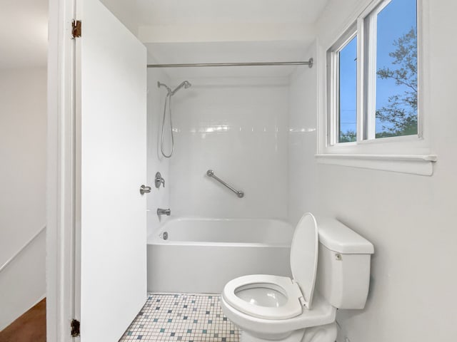 bathroom featuring toilet, shower / tub combination, and tile patterned flooring