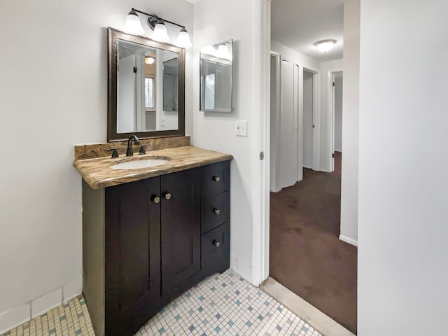 bathroom featuring vanity, baseboards, and tile patterned flooring